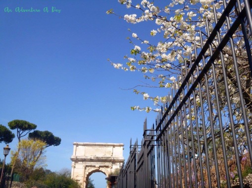 The arch of Titus and spring blossoms on a lovely spring day in Rome.